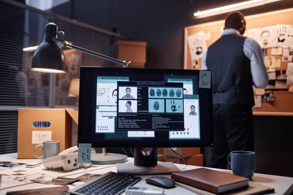 Private investigator reviewing digital evidence and case information